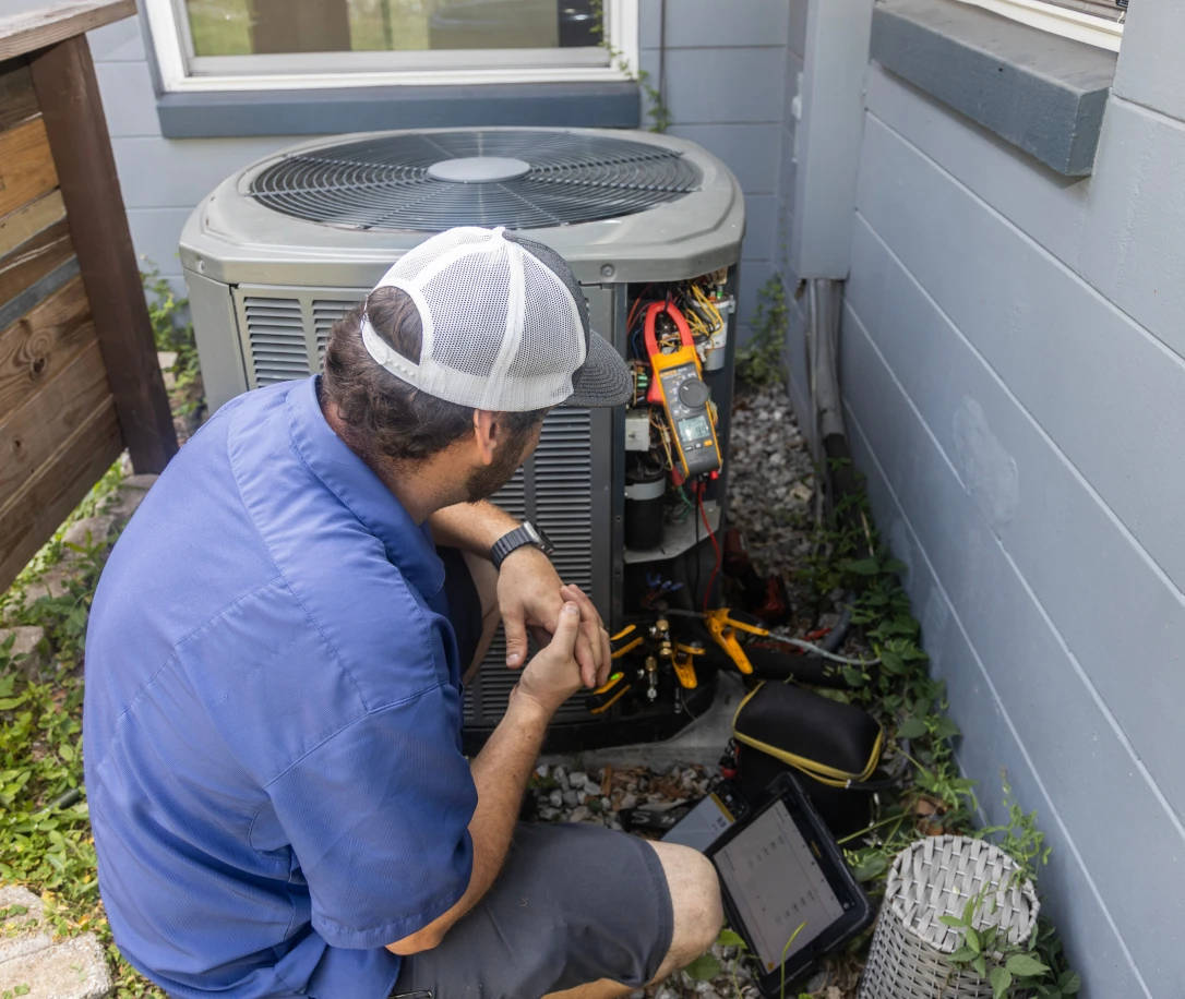 HVAC worker looking at HVAC unit