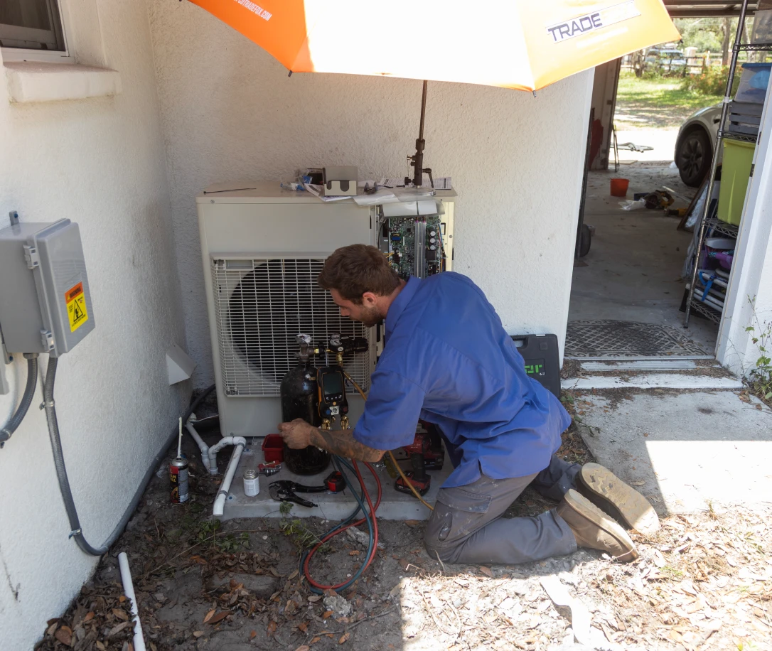 HVAC worker fixing an AC
