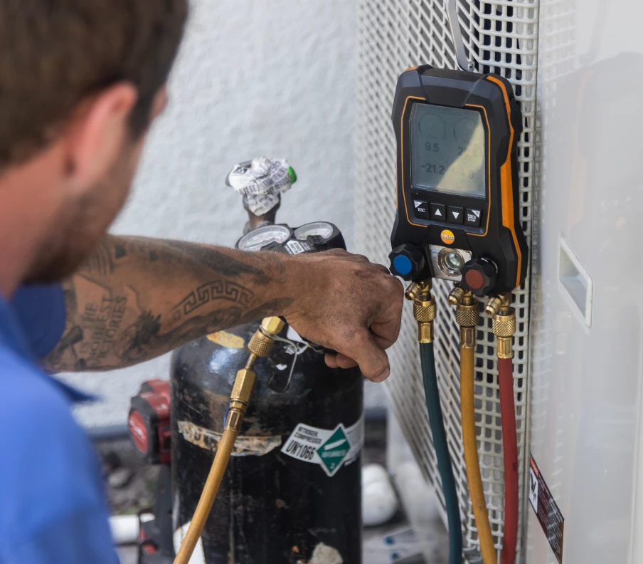 Greens HVAC Repair Technician servicing HVAC unit