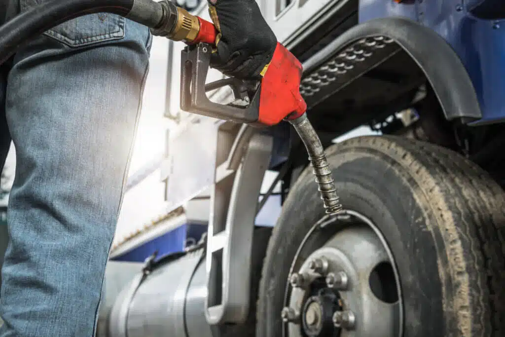 Person about to refuel a semi truck